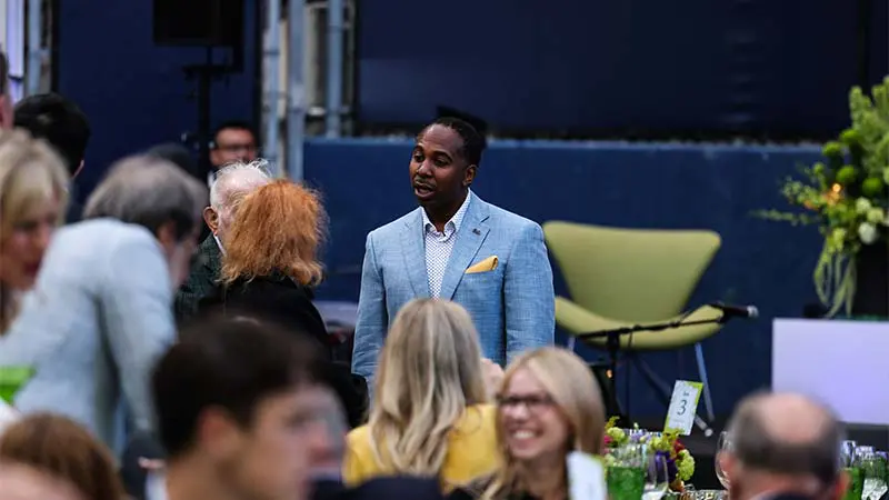 A man in a suite talking to someone